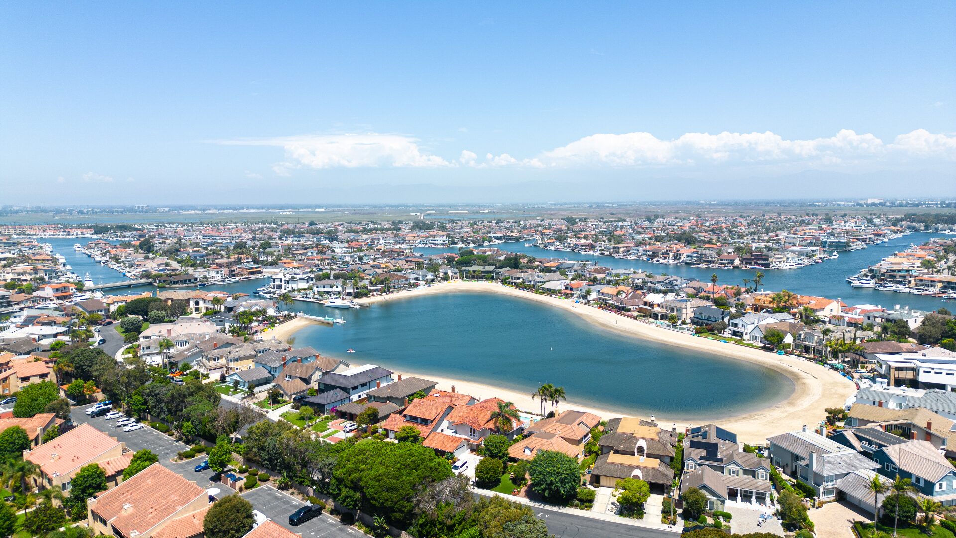 Aerial view of Huntington Harbour swim lagoon and waterfront homes near 17061 Pacific Coast Hwy