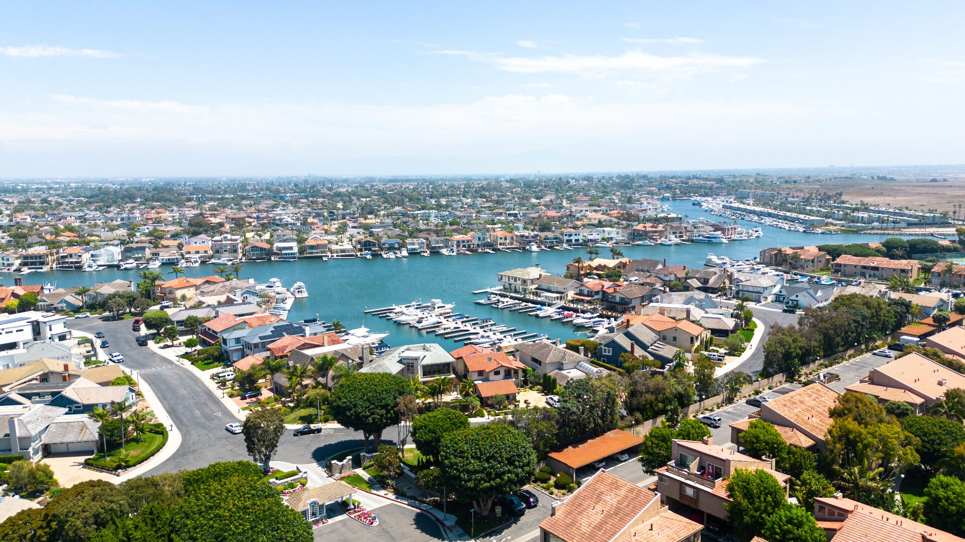 Aerial view of Huntington Harbour channels, private docks, and luxury homes near 17061 Pacific Coast Hwy