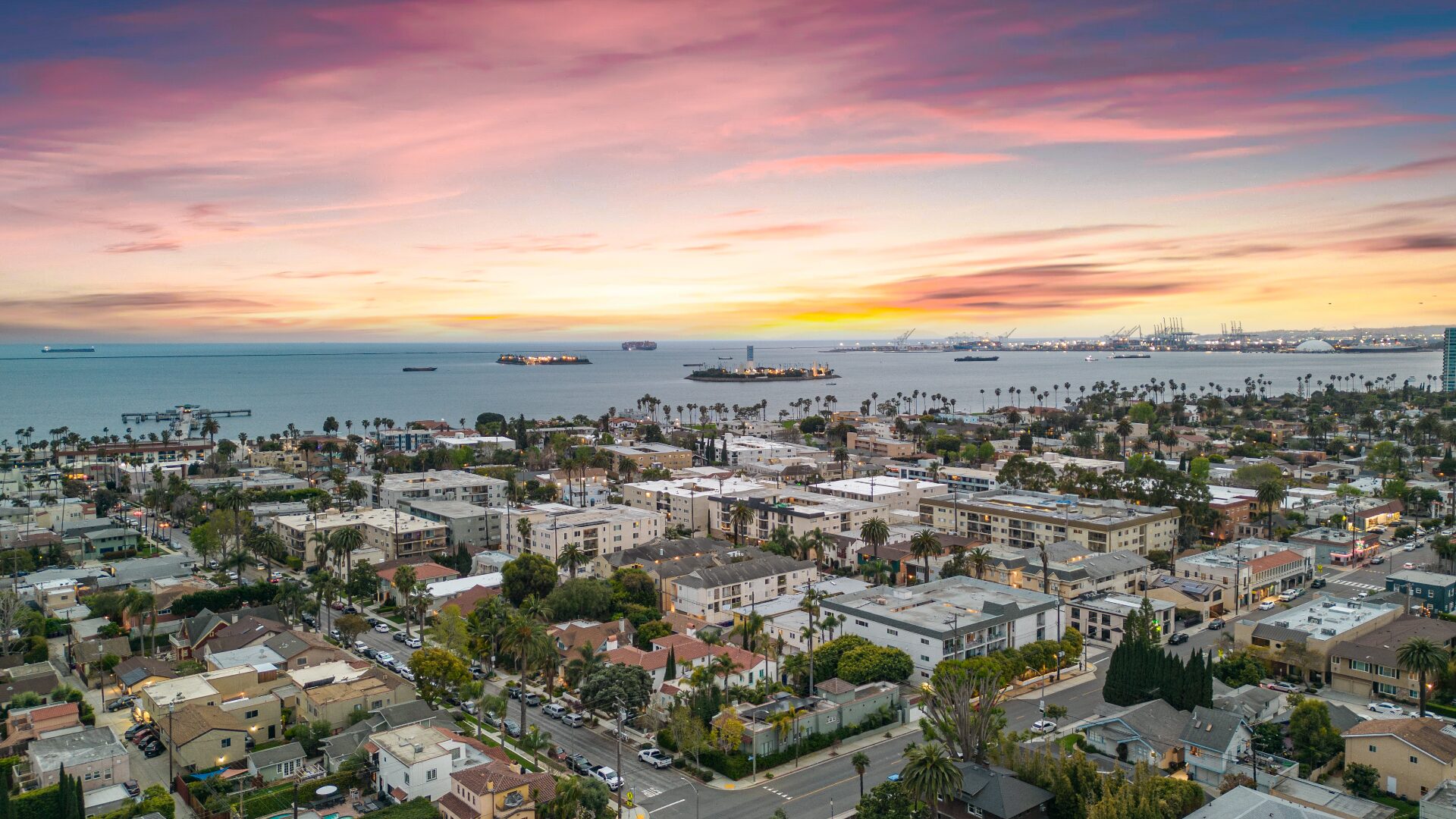 Sunset aerial view of the Long Beach coastline and harbor from 226 Grand Ave