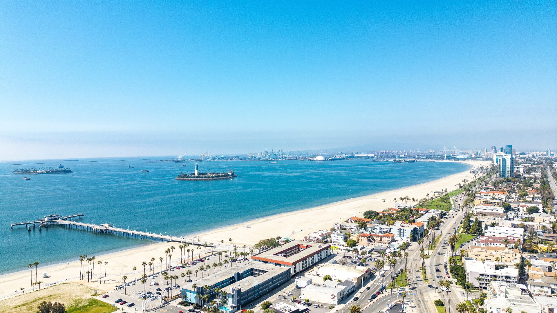 Daytime aerial view of Long Beach shoreline, pier, and lighthouse from 226 Grand Ave